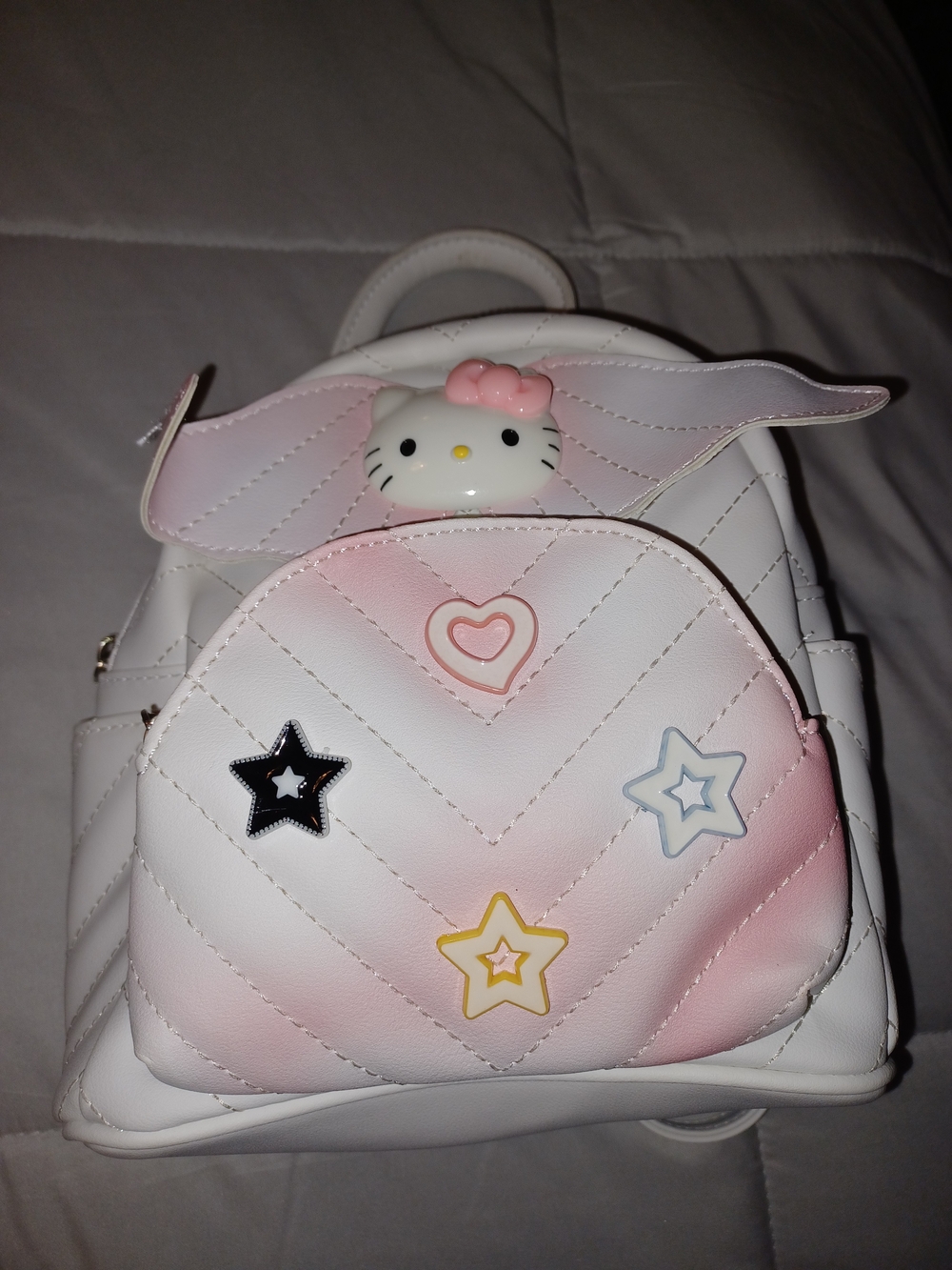white and pink kawaii Hello Kitty mini backpack featuring a quilted chevron patt